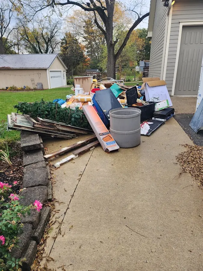 Dumpster being loaded with debris for 3 Yard Dumpster Rental in Westbury